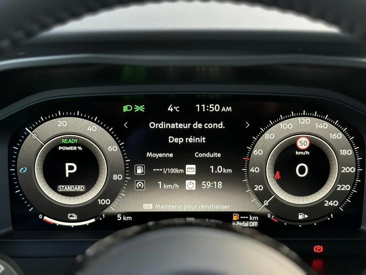 Tableau de bord numérique du Nissan Qashqai blanc nacré, affichage central des données de conduite à 11h50.