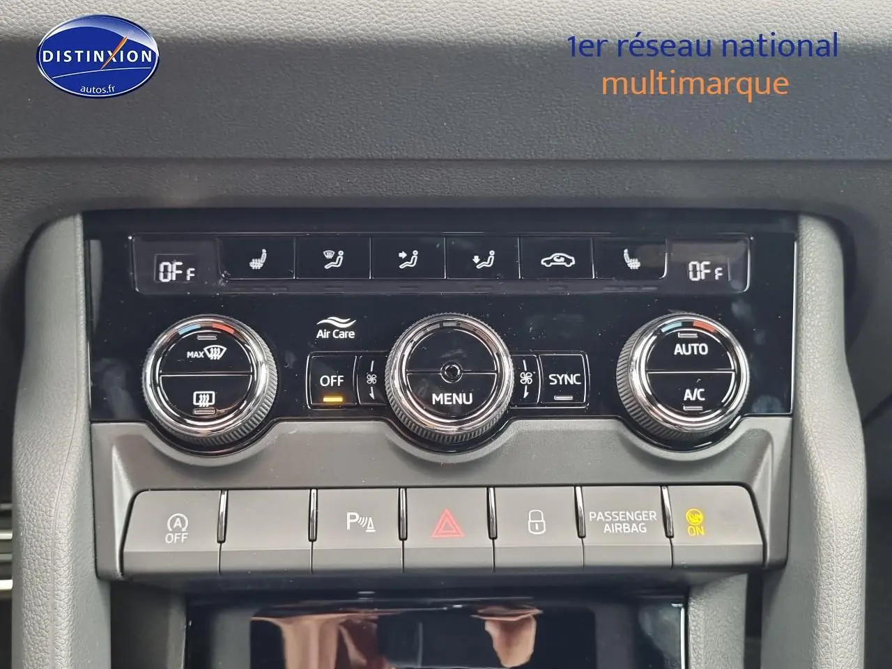 Tableau de bord de SKODA KAROQ noir, vue frontale centrée sur la console de climatisation et commandes.