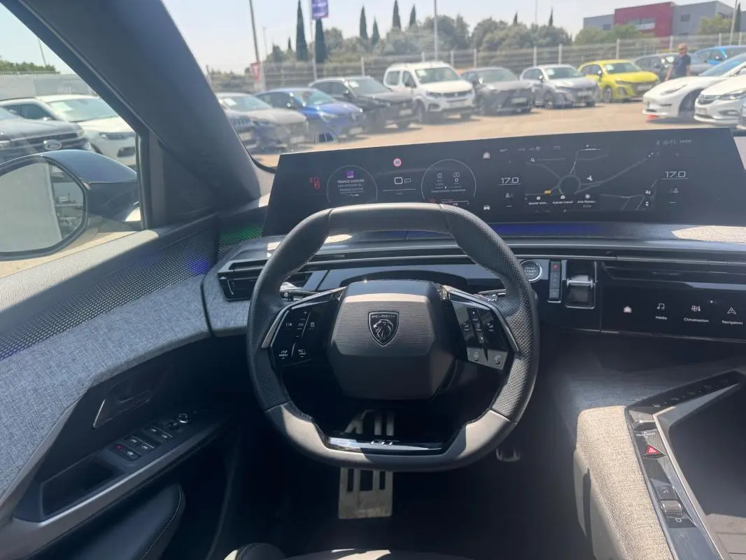Vue intérieure centrée sur le volant et le cockpit numérique du Peugeot 3008 Hybrid 145 e-DCS6 GT noir 2025.