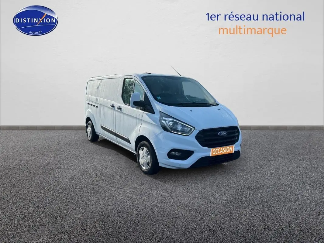Vue 3/4 avant droit d'un fourgon Ford Transit Custom blanc avec porte latérale et vitres surteintées.