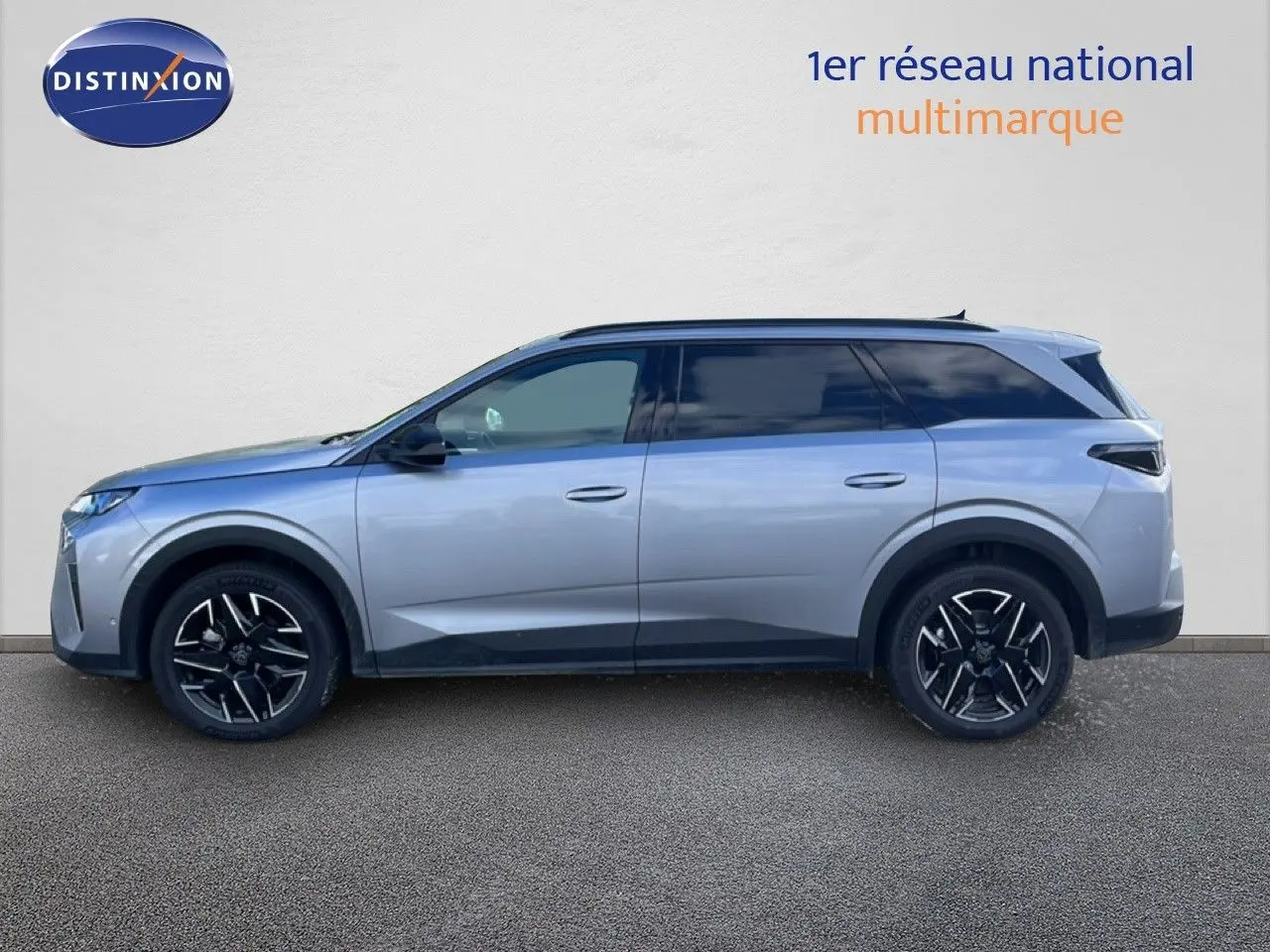 Profil droit du Peugeot 5008 Hybrid gris Artense métal 2025 avec jantes noires et toit panoramique.
