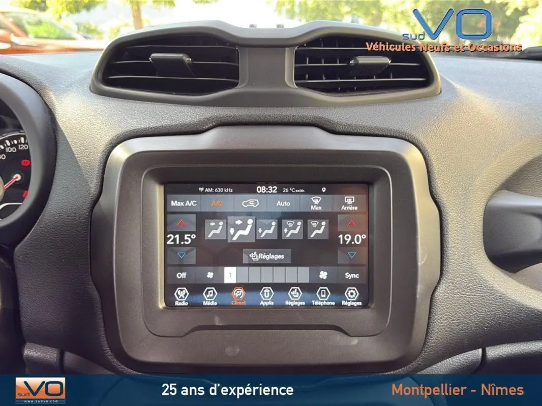 Écran tactile central du tableau de bord du Jeep Renegade blanc, affichant la climatisation automatique multi zone.