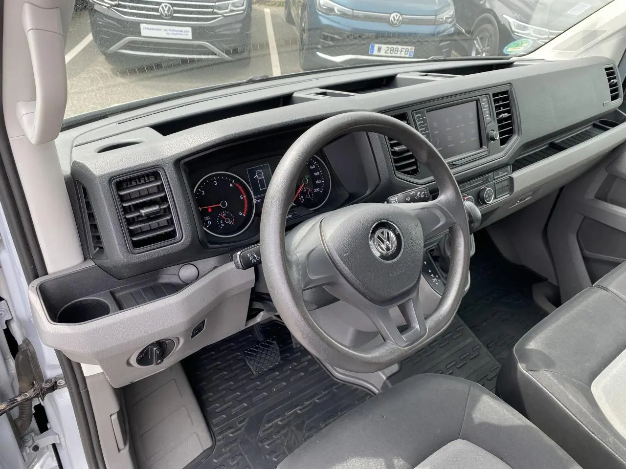 Intérieur du Volkswagen Crafter Business Line 2020, vue côté conducteur sur le tableau de bord et volant gris.