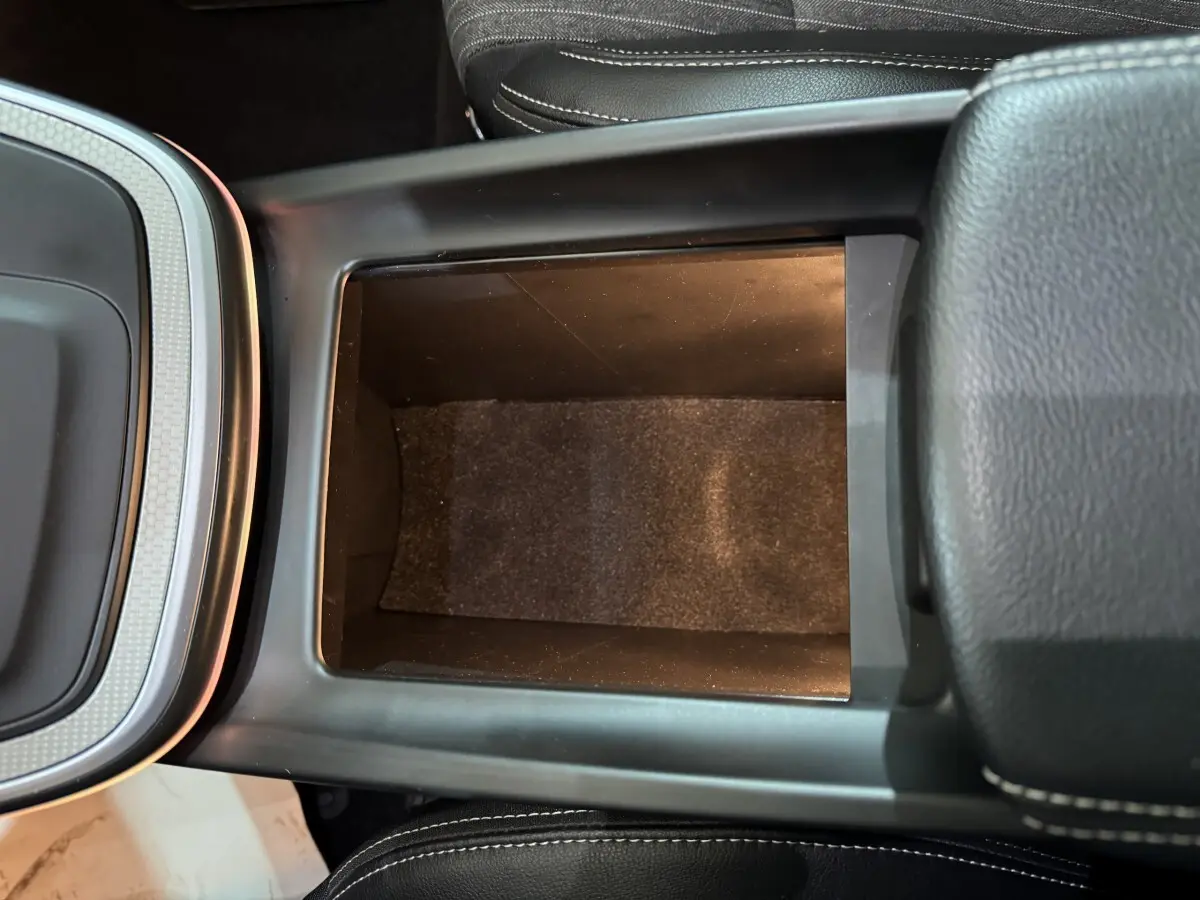 Vue plongeante sur le rangement central noir entre les sièges du Renault Scenic Intens TCe 160 EDC 2021.