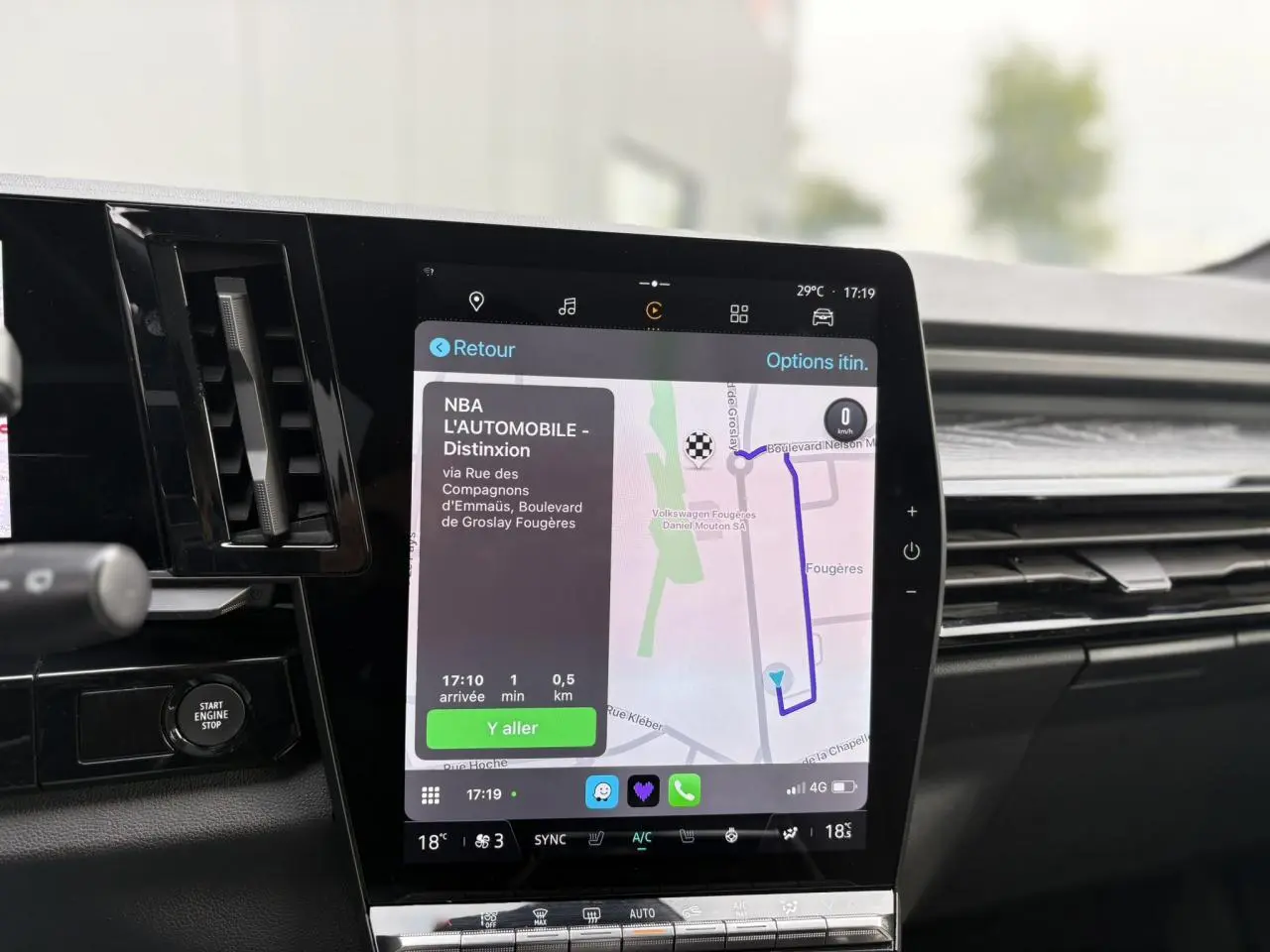 Écran tactile central du Renault Espace VI bleu Nuit affichant la navigation GPS avec interface moderne et commandes climatisation.