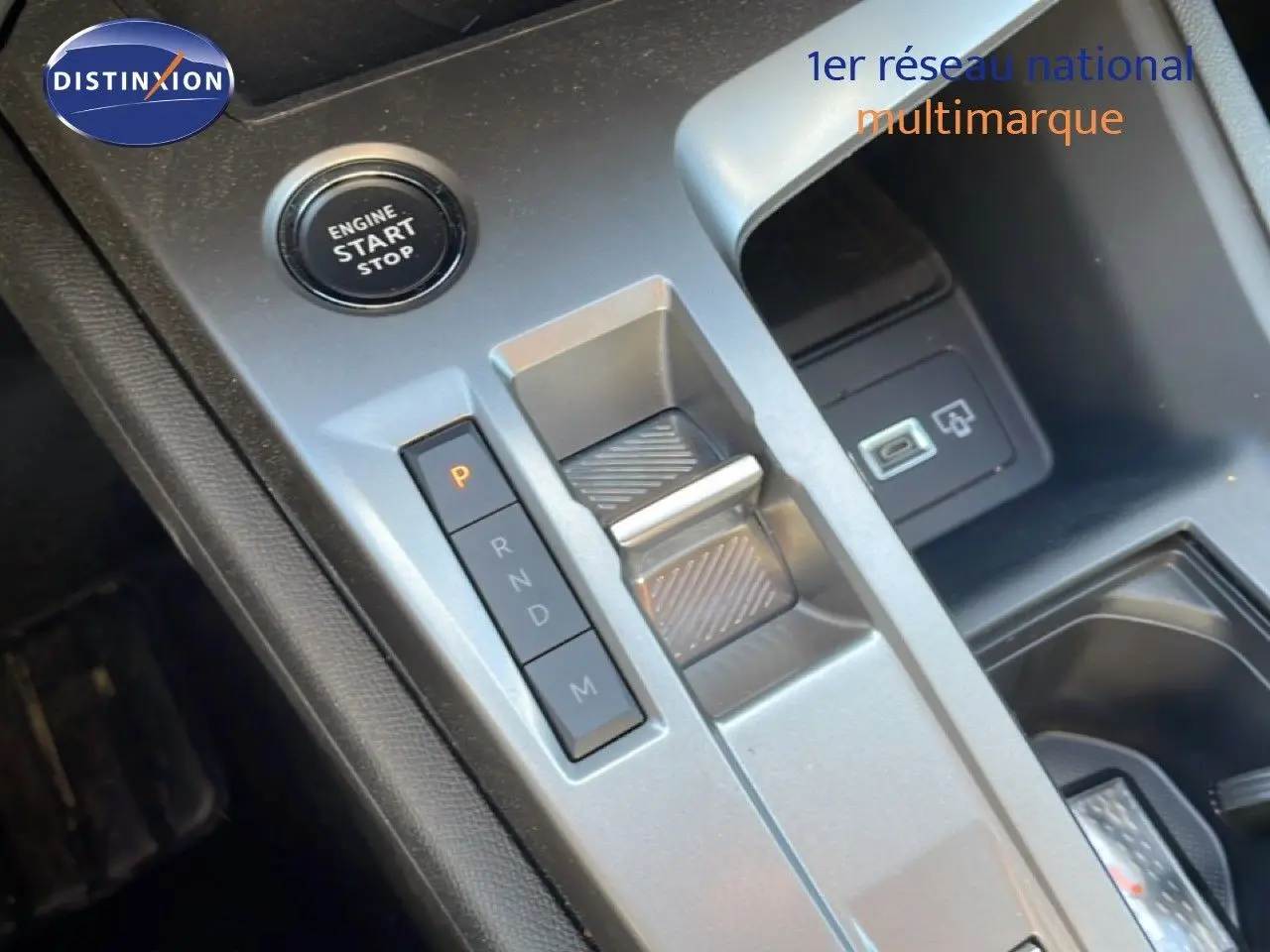 Gros plan sur la console centrale de la Peugeot 308 SW Hybrid 2025 avec bouton start/stop et commande de boîte automatique.
