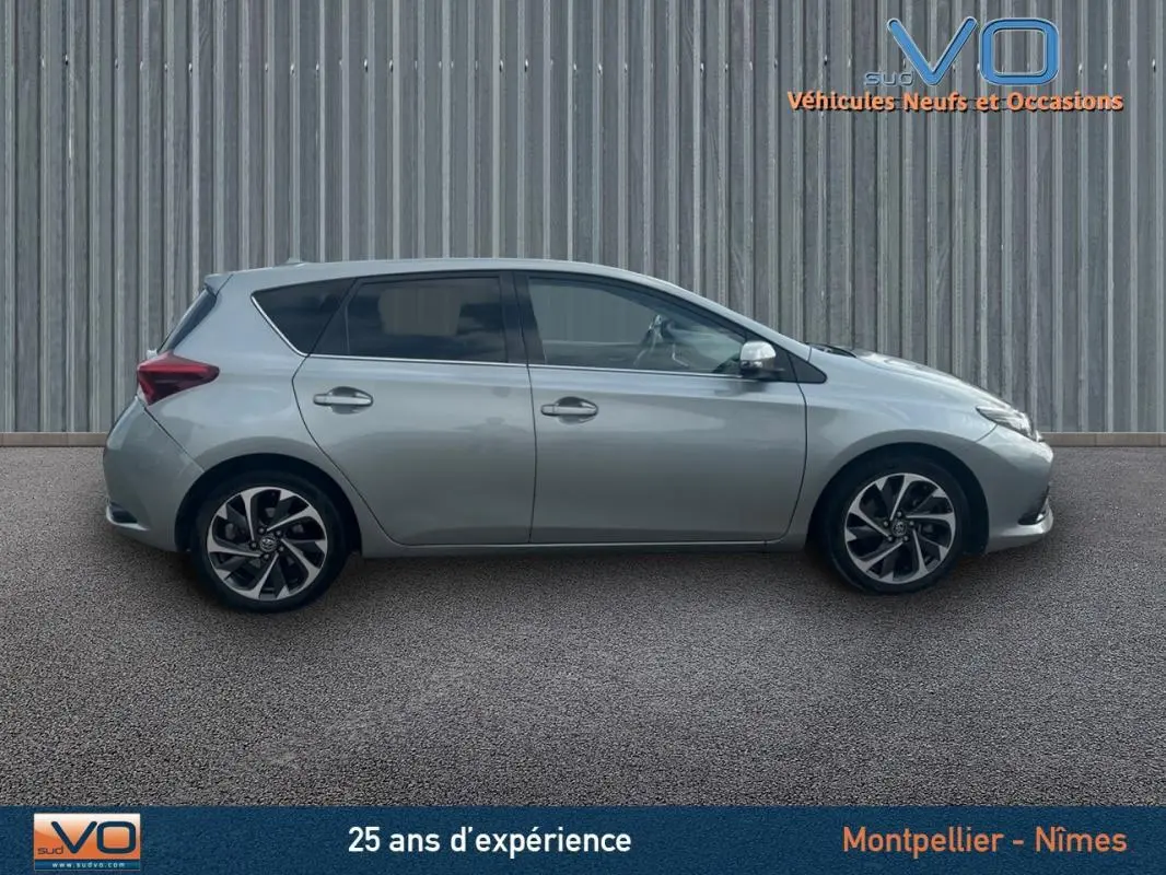 Profil côté gauche d'une Toyota Auris Business Hybride 136h Design gris clair avec jantes alliage 17 pouces.