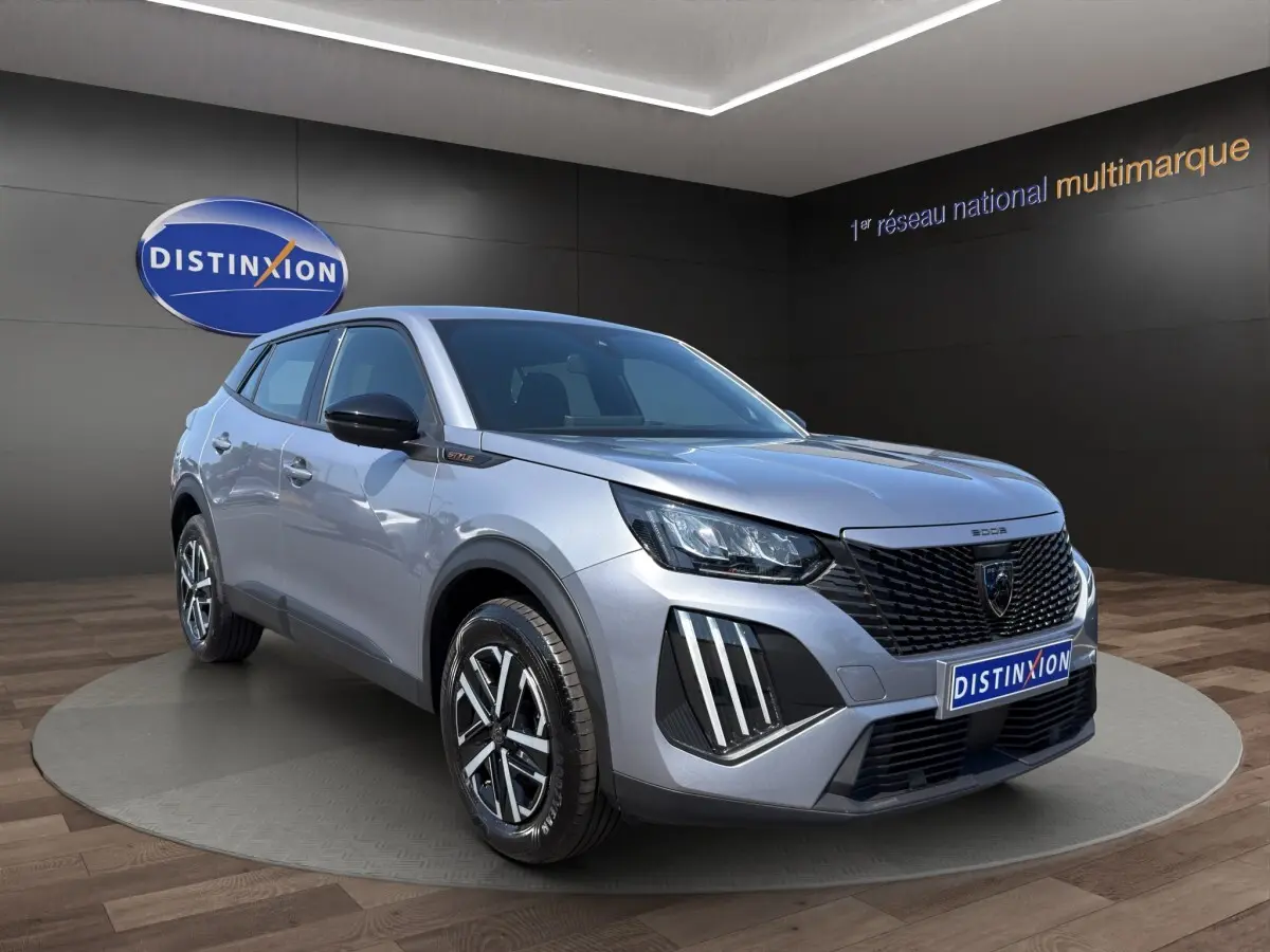 Peugeot 2008 Hybrid gris clair vue 3/4 avant droit, avec calandre noire et feux LED distinctifs.