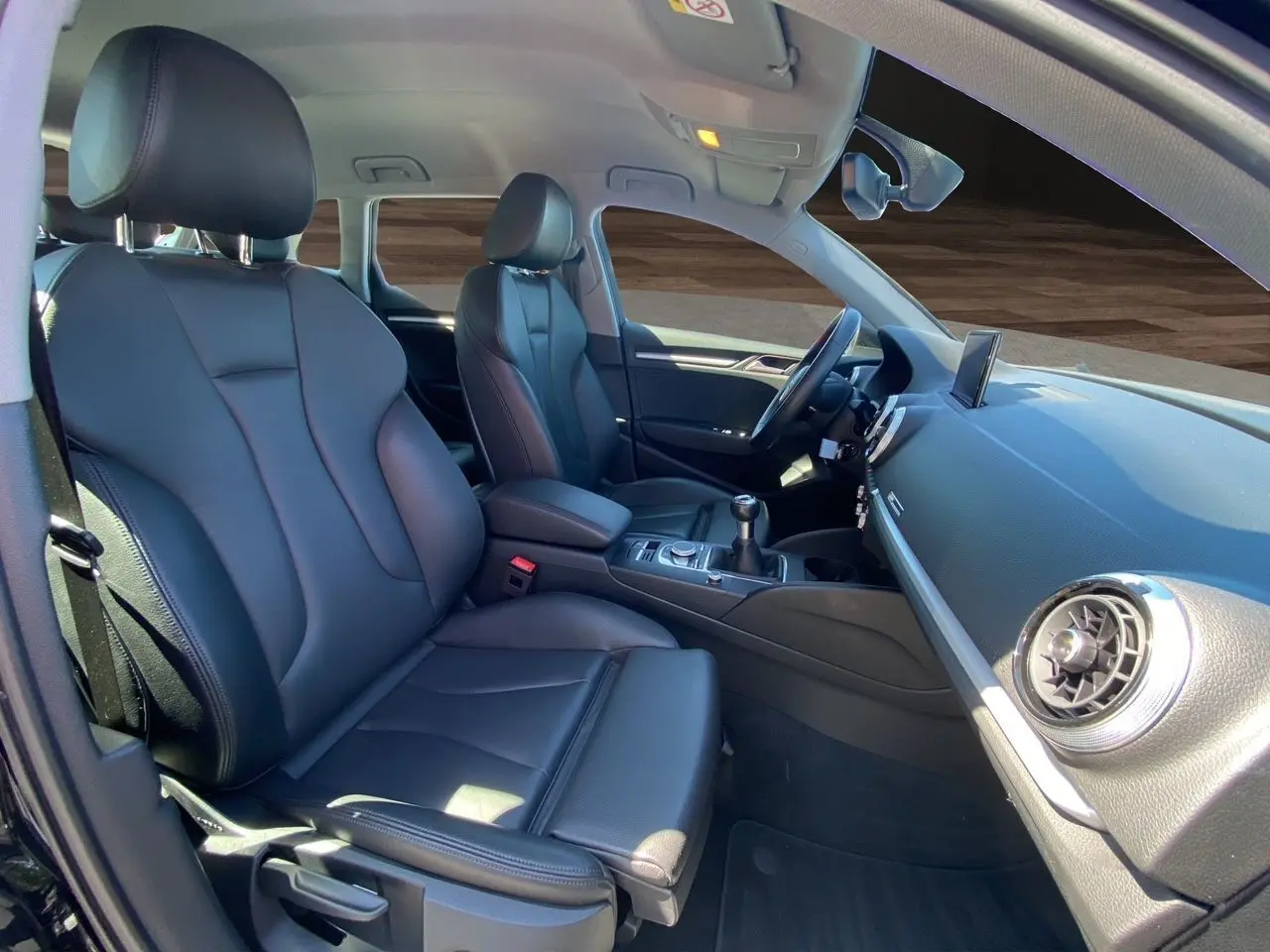 Intérieur noir cuir de l'Audi A3 Sportback 2020, vue côté droit sur sièges sport et tableau de bord avec écran central.