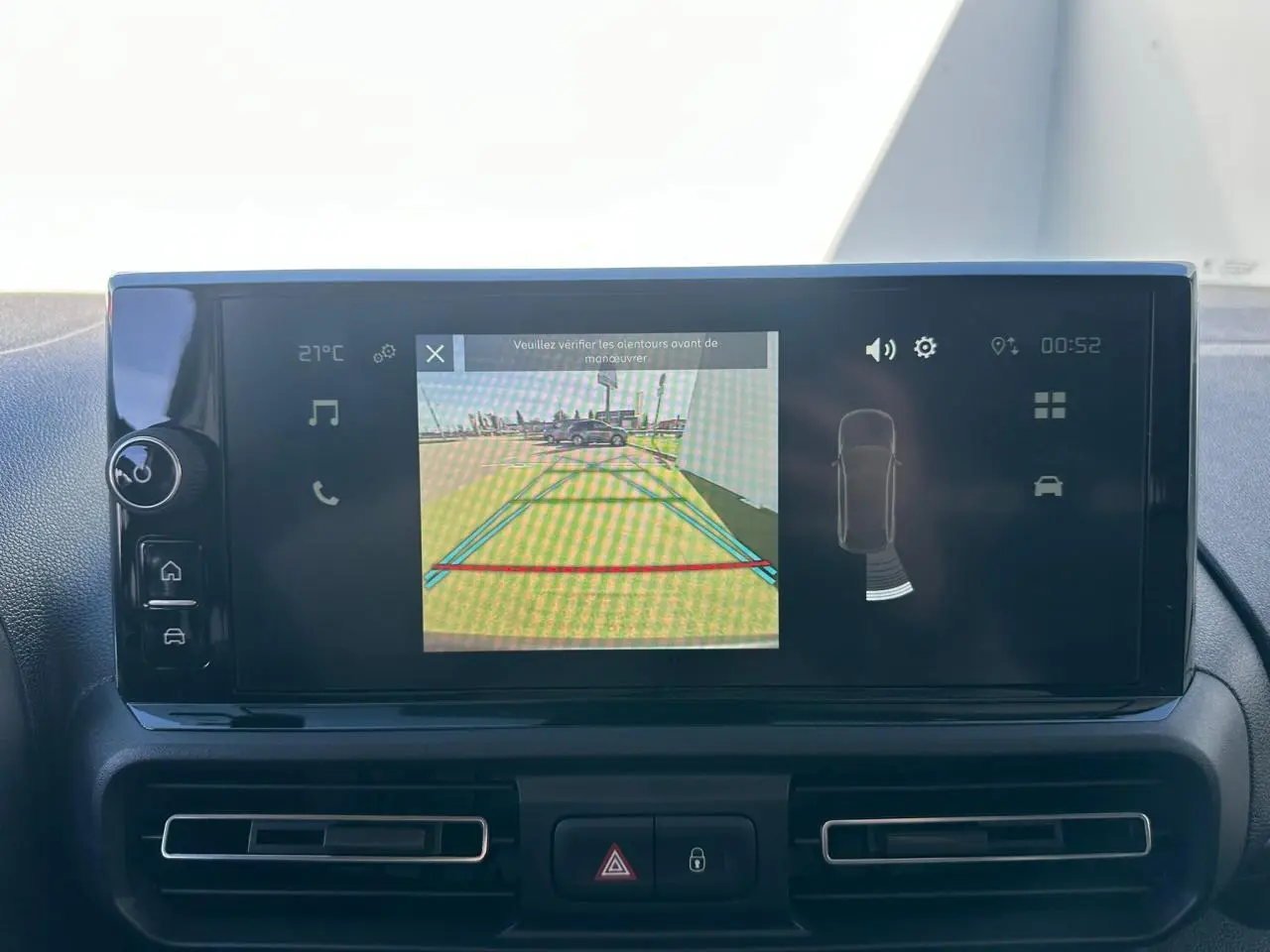 Gros plan sur le réglage manuel du siège conducteur en tissu noir dans l'habitacle du Citroën Berlingo blanc Icy.