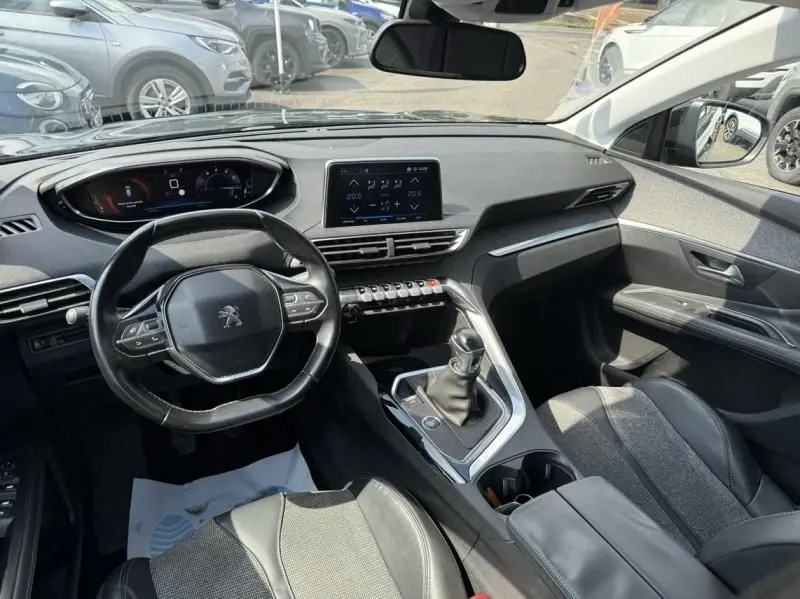 Intérieur du Peugeot 3008 noir 2018, vue de face sur le tableau de bord avec volant compact et écran tactile central.