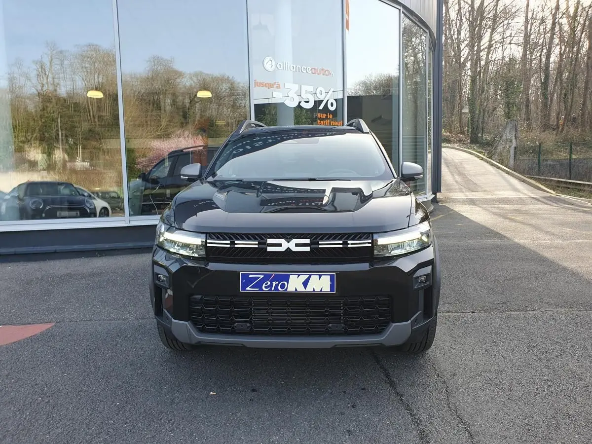 Vue frontale d'un Dacia Bigster noir Perla avec signature lumineuse LED et toit panoramique visible.