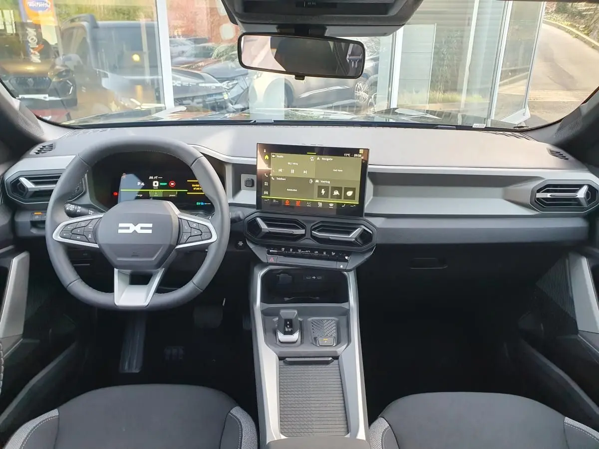 Vue intérieure frontale du tableau de bord du Dacia Bigster 2026 avec écran tactile et volant multifonction.