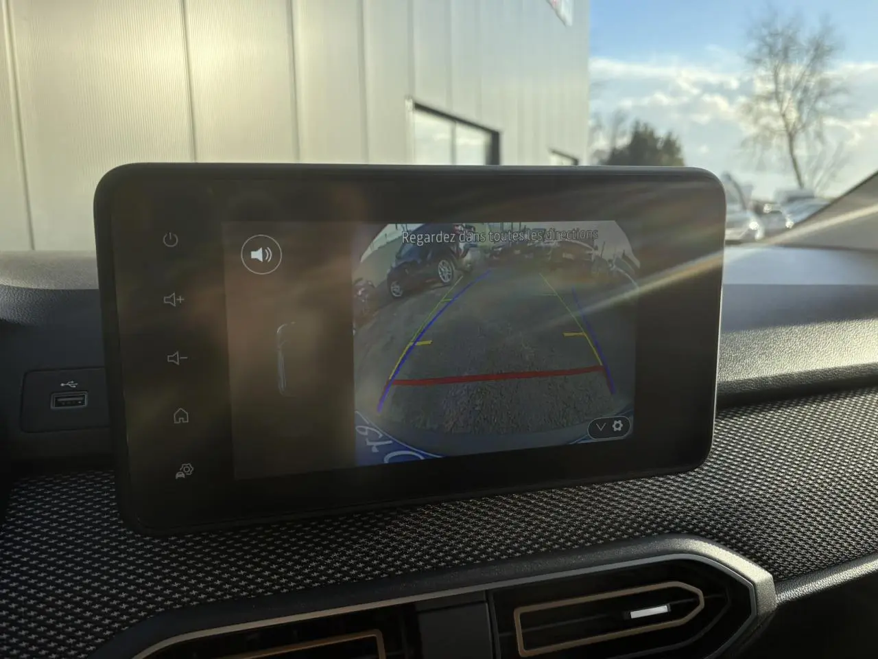 Écran tactile intérieur montrant la caméra de recul du Dacia Sandero Stepway blanc glacier, vue du tableau de bord.