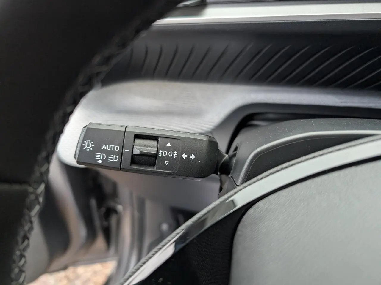 Gros plan sur la commande des feux et clignotants à gauche du volant d’un Citroën C3 Aircross 2025 gris métallisé.