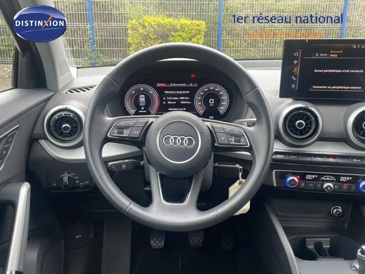 Vue intérieure centrée sur le volant Audi Q2 30 TDI S-Line 2025 avec tableau de bord numérique et commandes intégrées.