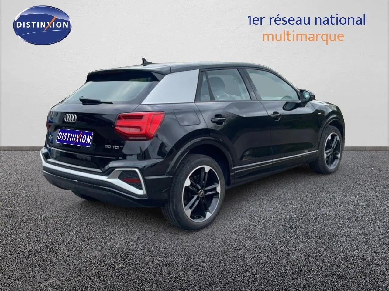 Audi Q2 noir mito metal vue 3/4 arrière droit, jantes alliage noires et toit contrasté gris clair.