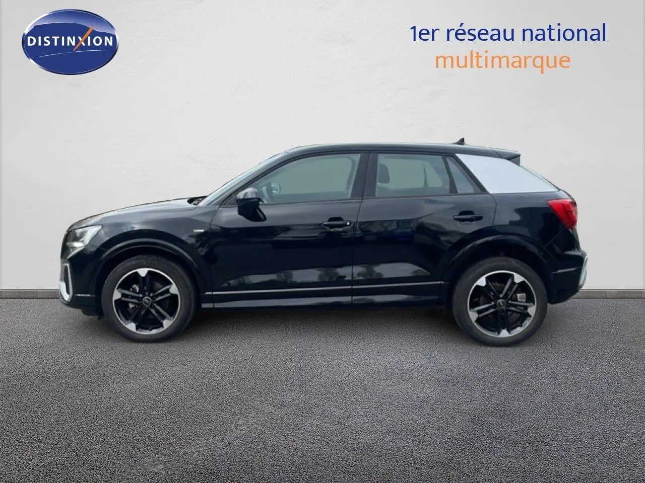 Profil latéral droit d'un Audi Q2 30 TDI S-Line noir mito metal avec jantes noires et toit contrasté gris clair.