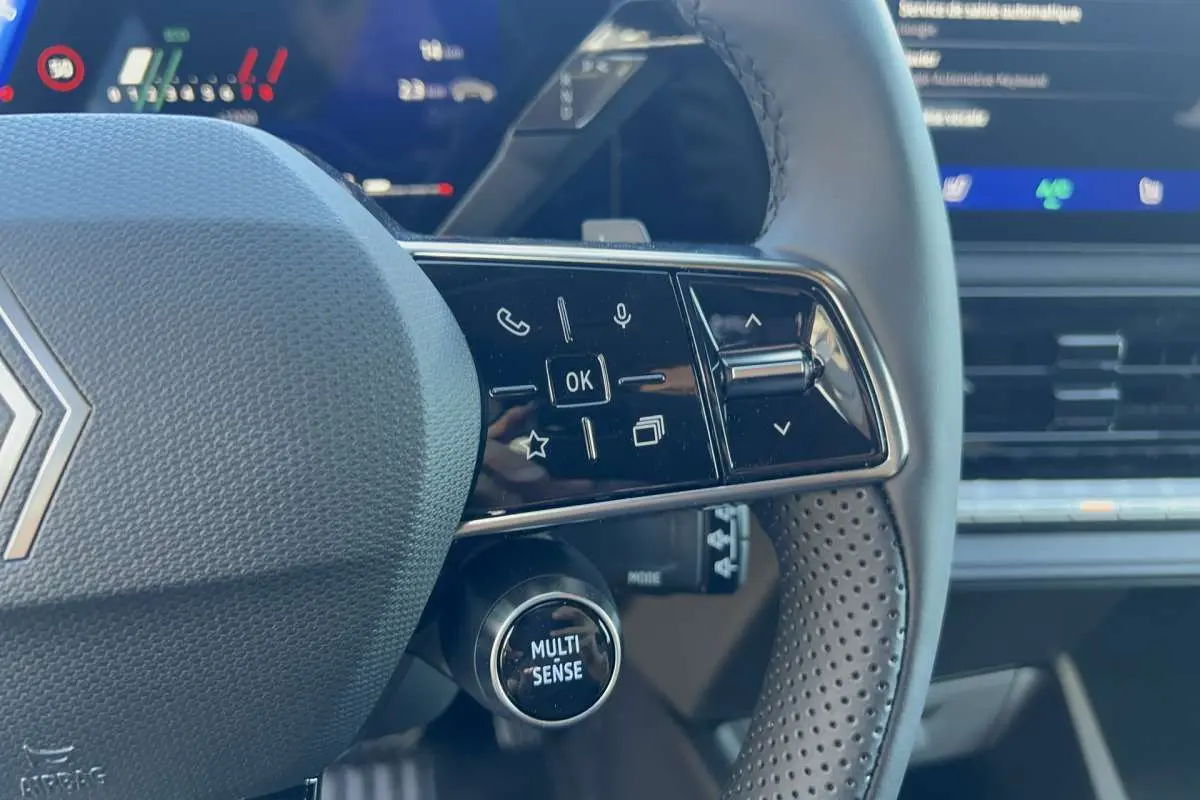 Gros plan sur le volant multifonctions de la Renault Clio 6 TCE 115 EDC Techno Plus avec bouton Multi Sense visible.