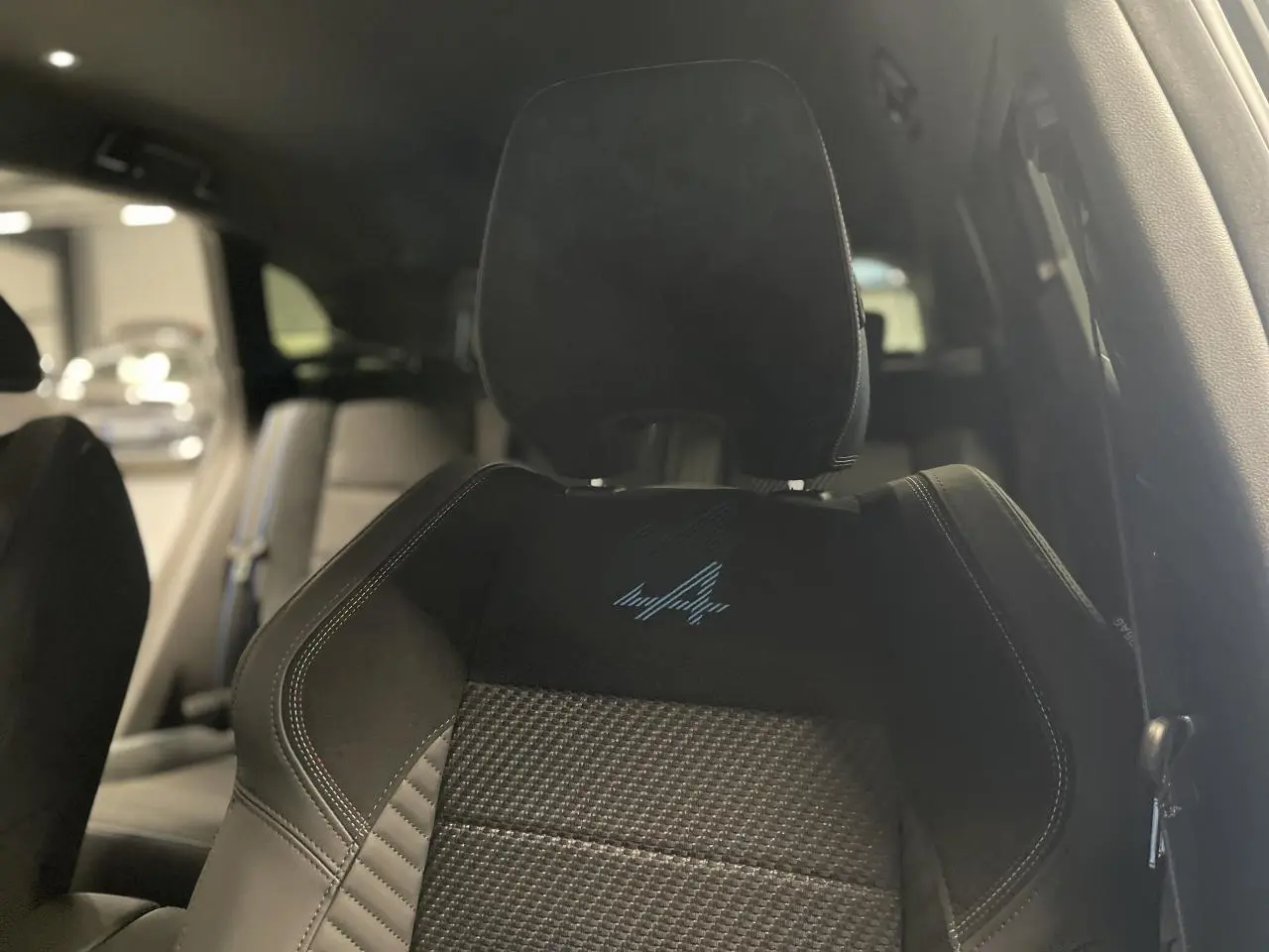 Gros plan sur le siège avant avec logo Alpine brodé, intérieur noir du Renault Austral Esprit Alpine 2025.