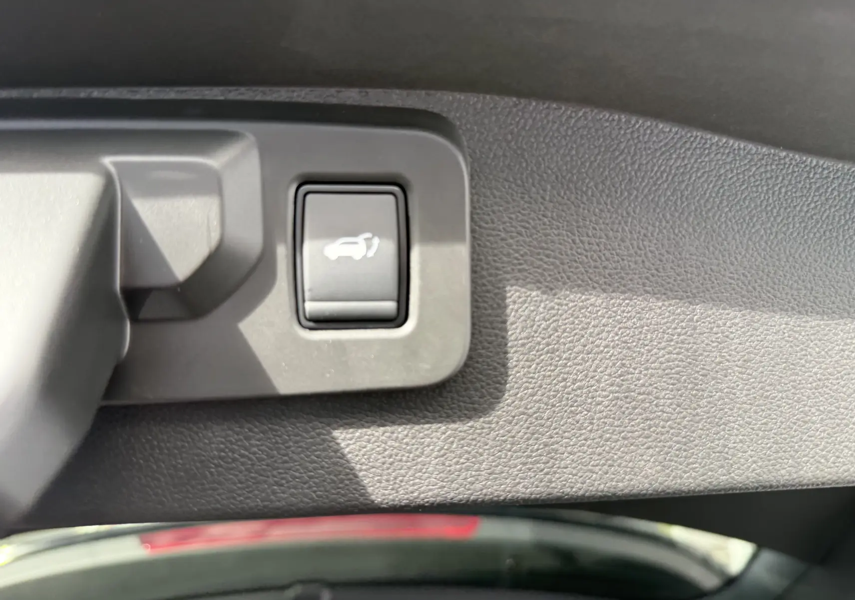Coffre ouvert vu de l'arrière d'un Renault Austral noir étoile, montrant un espace de chargement propre et spacieux.