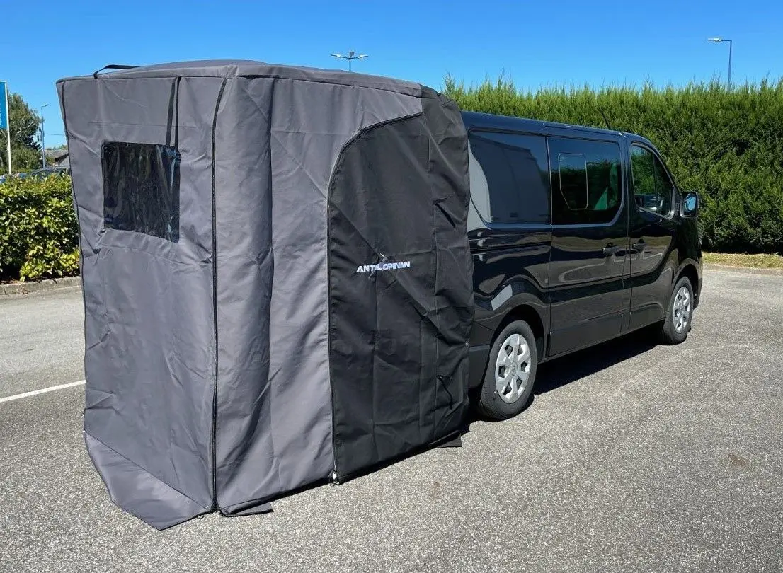 Vue 3/4 arrière droite d’un Renault Trafic Fourgon gris comète avec auvent latéral Antilope Van installé.