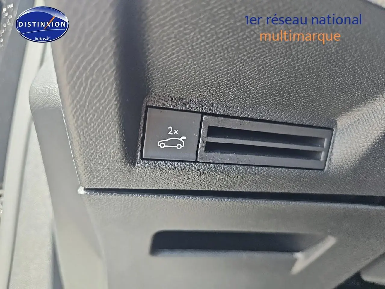 Gros plan sur bouton d'ouverture du coffre dans l'habitacle noir du Peugeot 3008 1.2 hybrid 145 GT 2025.