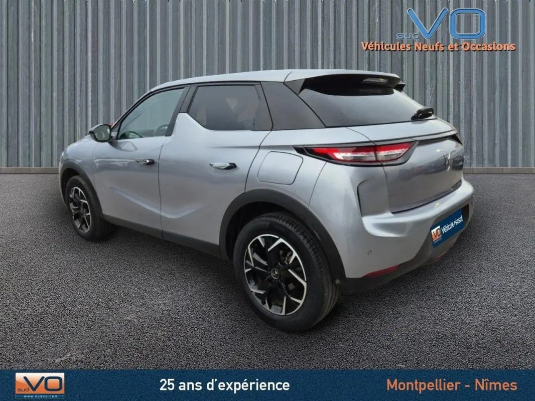 Vue 3/4 arrière droite d'un DS3 Crossback gris 2020 avec jantes alliage noires et toit noir contrasté.