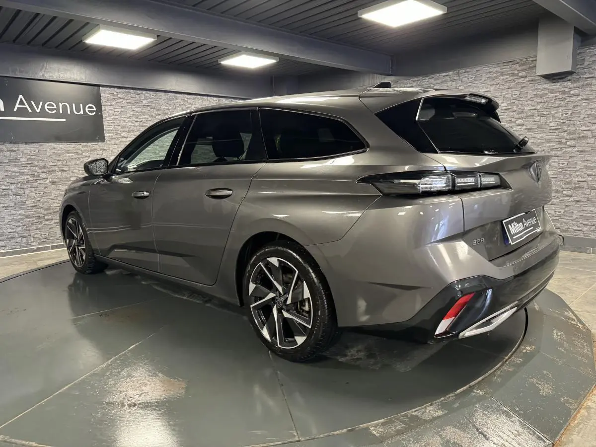 Peugeot 308 SW gris métallisé vue 3/4 arrière droit avec jantes alliage 17'' et feux arrière LED distinctifs.