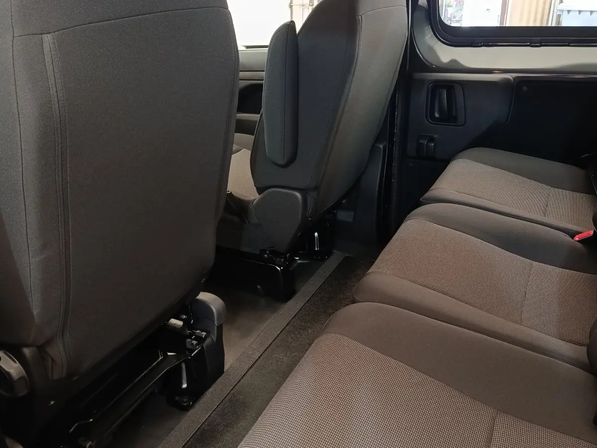 Vue intérieure côté droit sur la banquette arrière et les sièges avant gris foncé du Citroën Jumpy 2025.