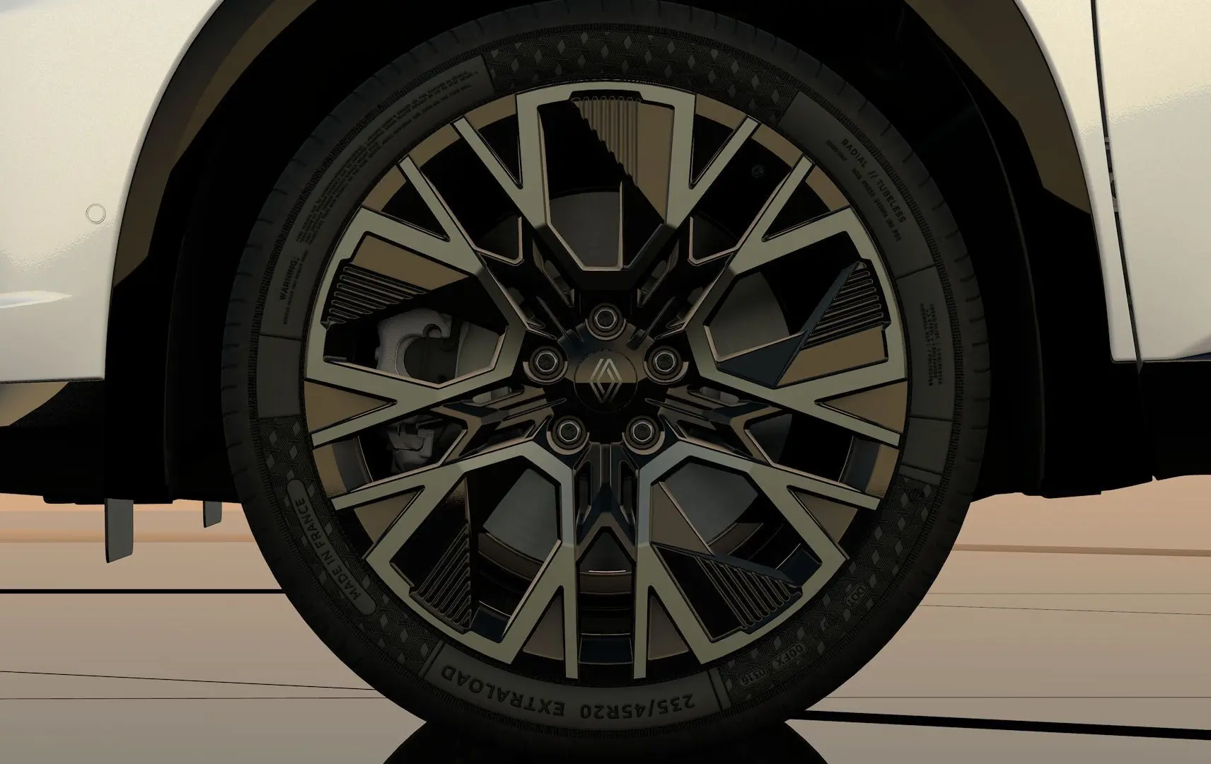 Gros plan sur la roue avant droite du Renault Austral blanc nacré, jante noire au design géométrique distinctif.