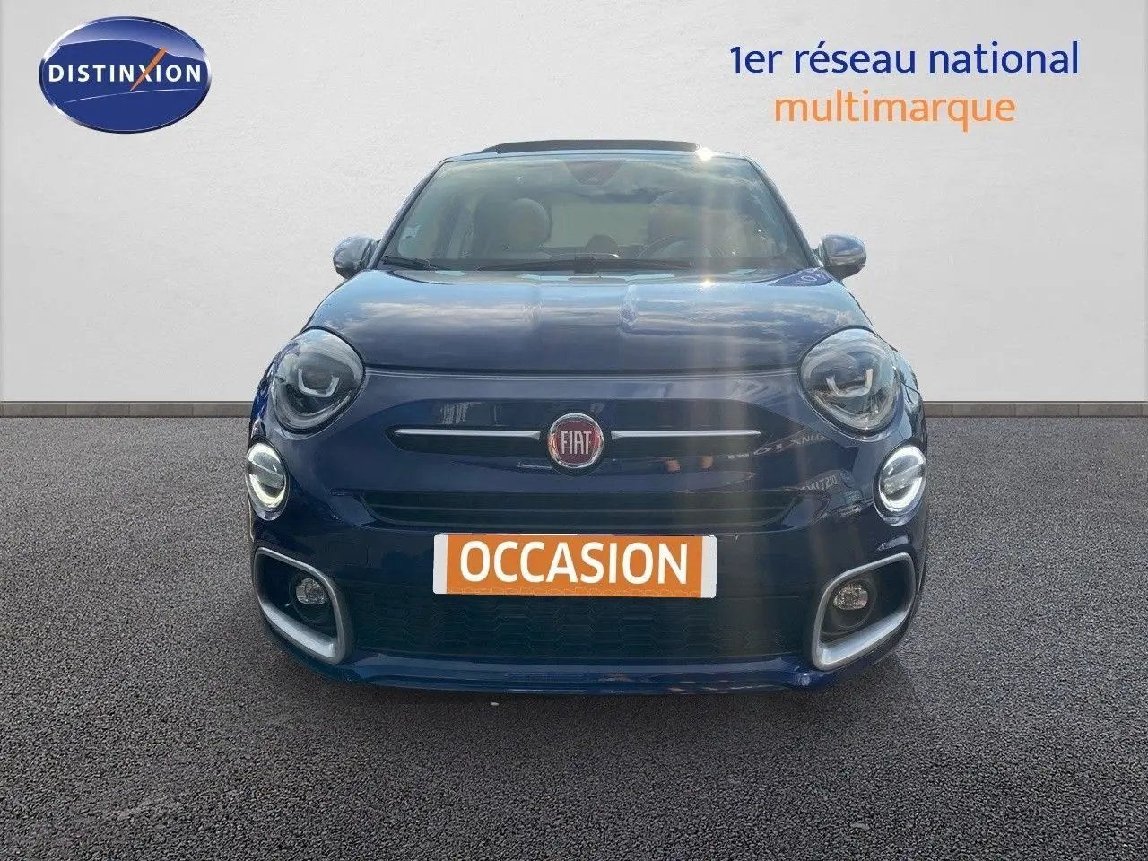 Vue frontale d'une Fiat 500X bleu Venezia métal avec phares LED et plaque d'occasion visible.