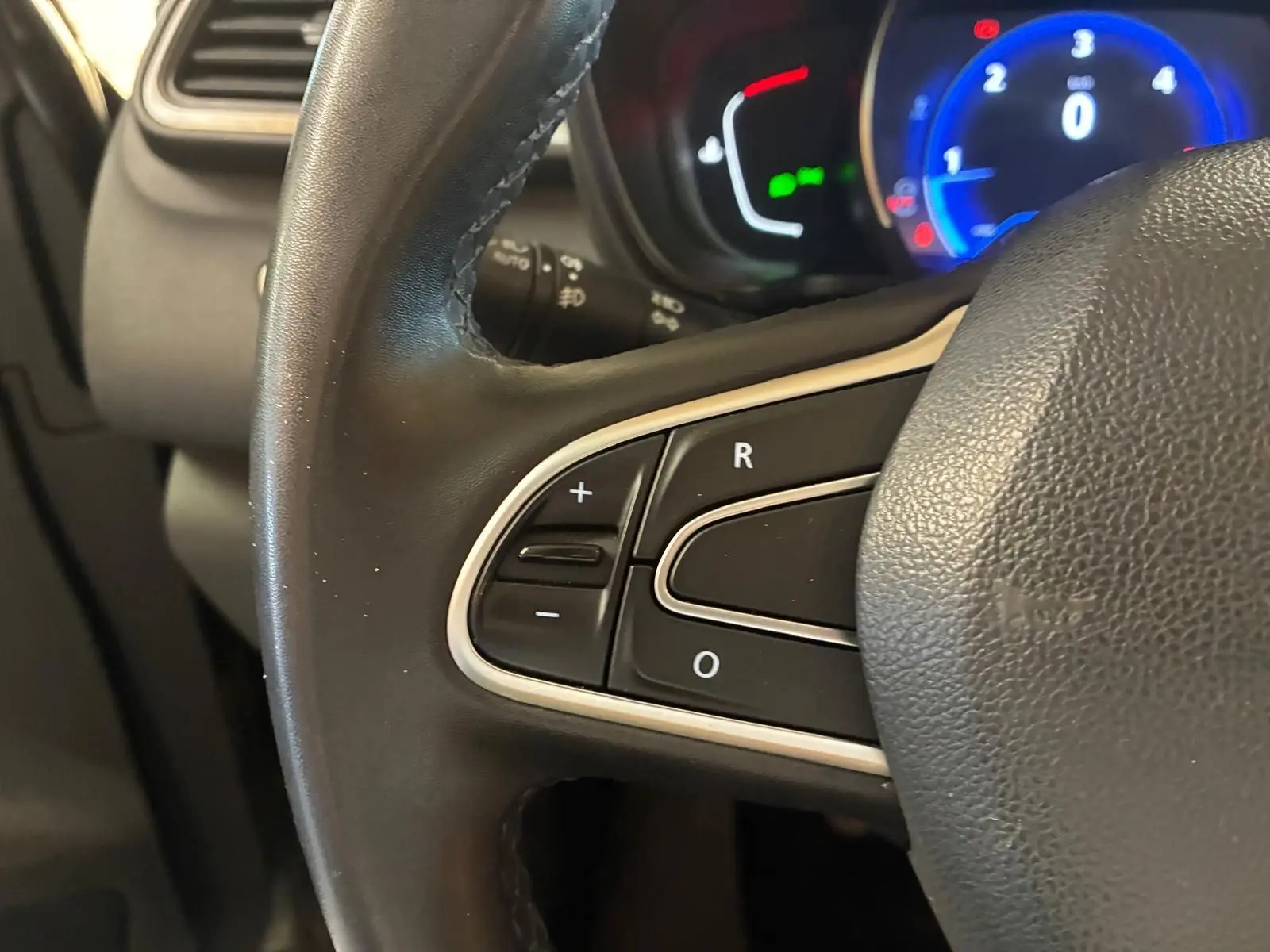 Gros plan sur le volant noir du Renault Kadjar 2019 avec commandes intégrées et tableau de bord éclairé en bleu.