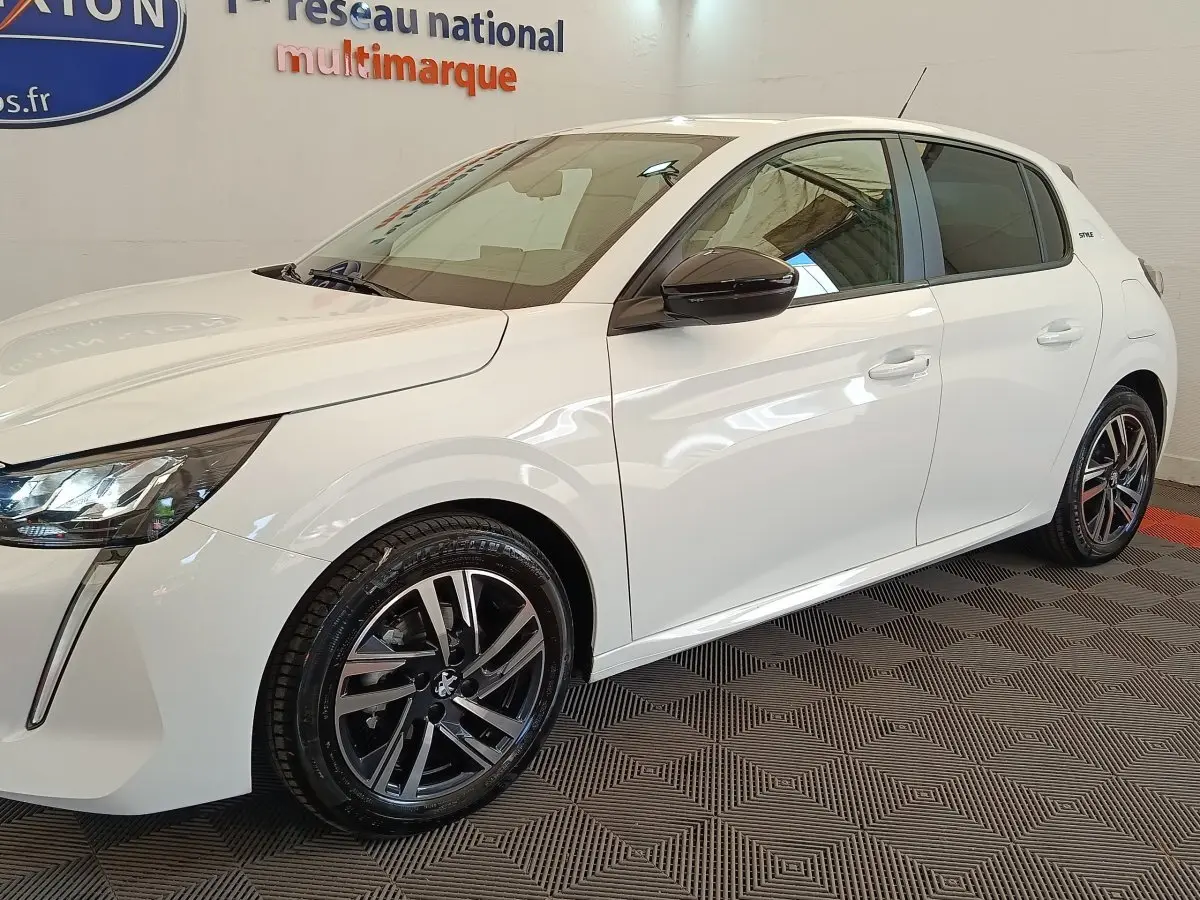 Peugeot 208 PureTech 75 S&S Style blanc vue 3/4 avant droit avec jantes alliage et rétroviseurs noirs.