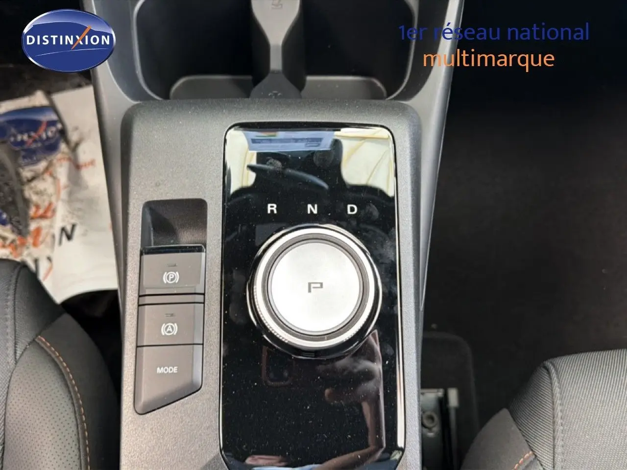 Vue plongeante sur la console centrale de la MG3 1.5L Hybrid+ 195CH Luxury avec sélecteur rotatif de boîte auto et finition noire brillante.