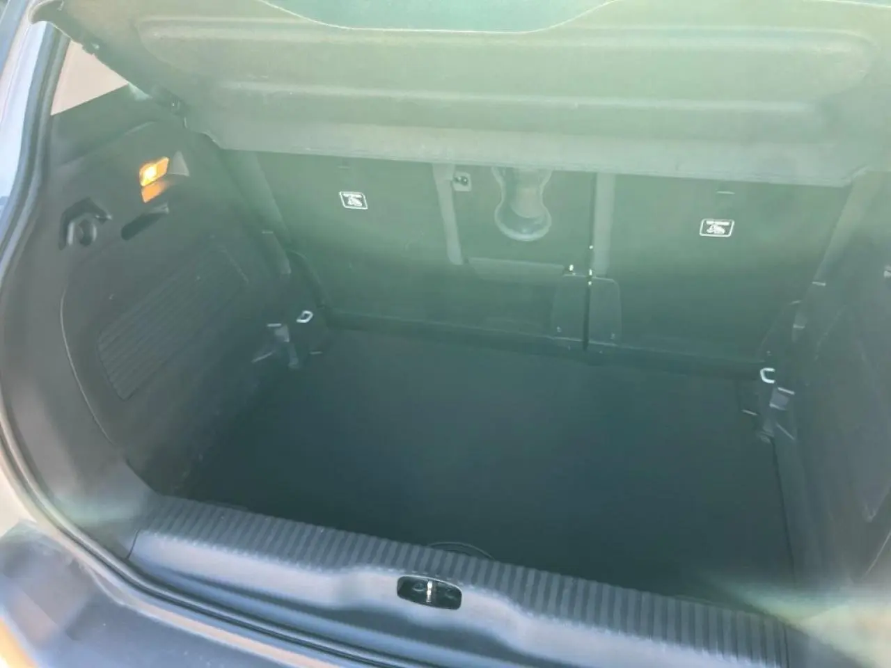 Coffre ouvert d'une Citroën C3 Aircross beige, montrant l'espace de chargement et l'attelage col de cygne.