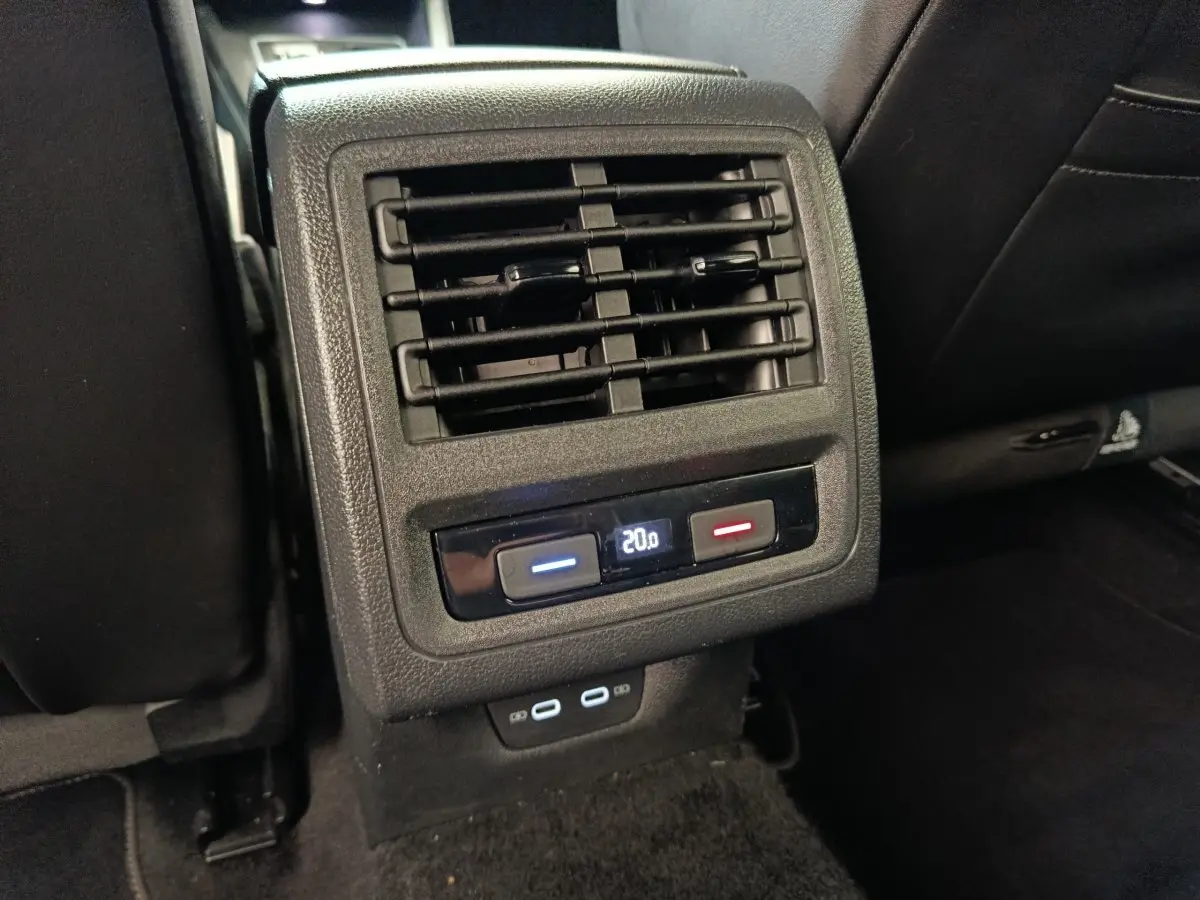 Détail de la console arrière noire de la Volkswagen Golf 1.5 eTSI R-Line avec commandes climatisation et ports USB.