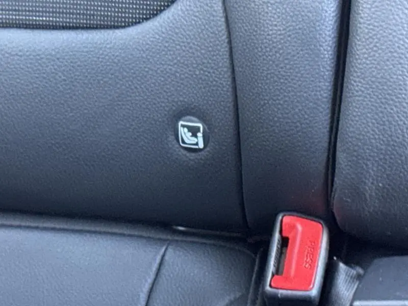 Détail intérieur montrant l'icône ISOFIX sur la banquette arrière en cuir noir du Kia Stonic brun Sienne.