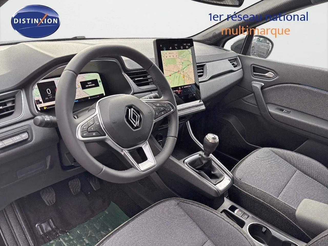 Vue intérieure côté conducteur du Renault Captur II 1.6 E-Tech hybride 2025, tableau de bord gris et écran tactile vertical.