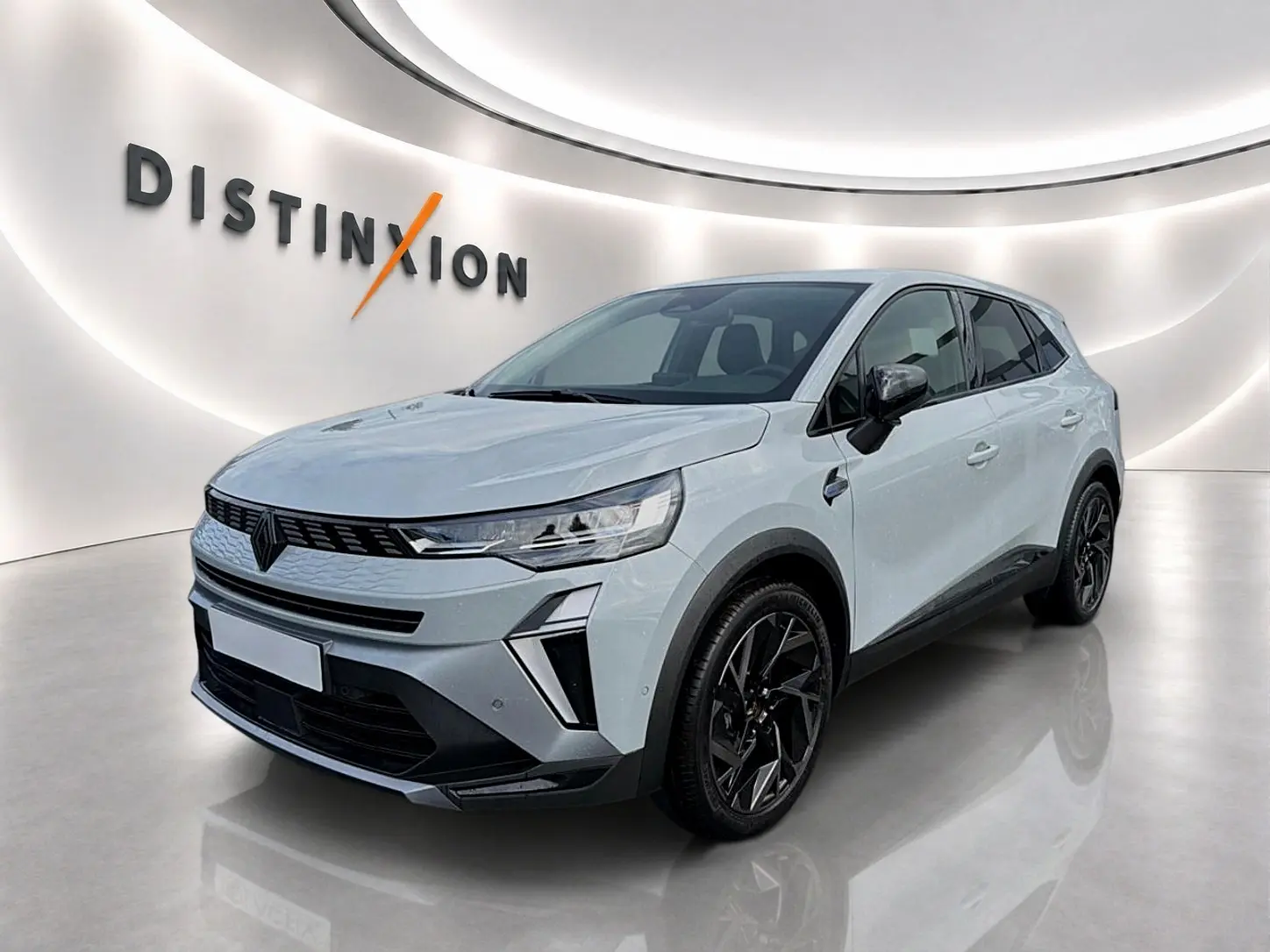 Renault Symbioz 2026 gris rafale en 3/4 avant droit, avec jantes noires et calandre moderne dans un showroom lumineux.