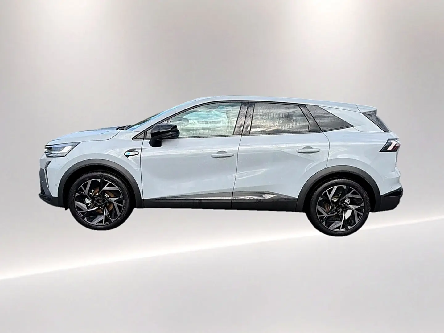 Profil droit du Renault Symbioz gris rafale, SUV hybride avec jantes noires et détails noirs contrastants.