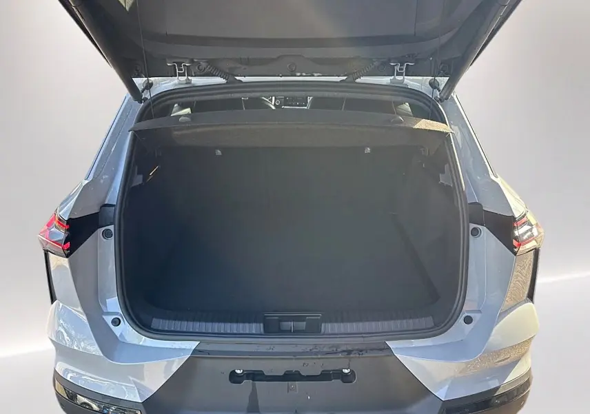 Vue arrière avec coffre ouvert d'une Renault Symbioz gris rafale, mettant en valeur l'espace de chargement.