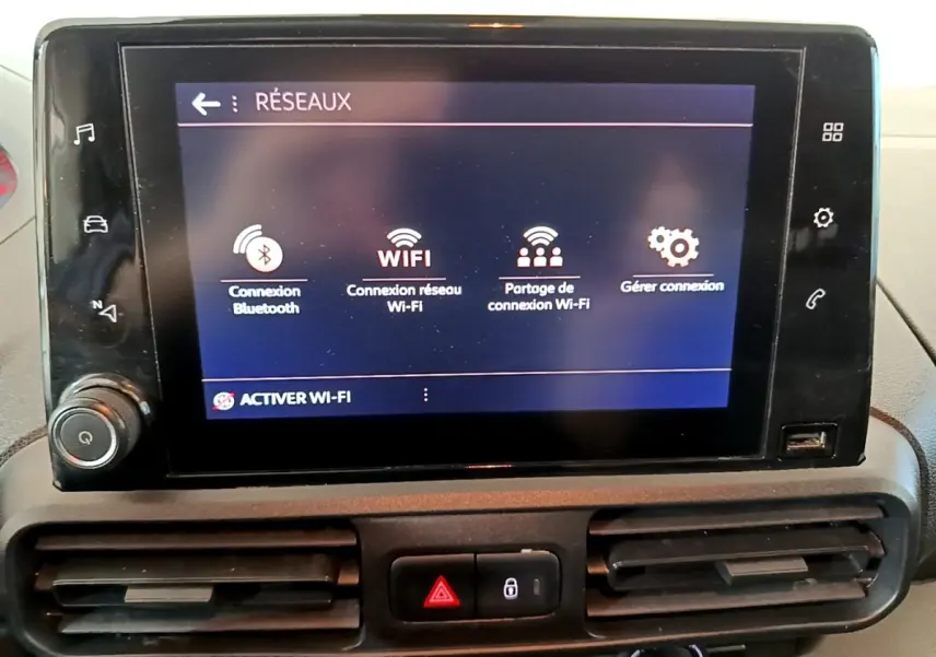 Écran tactile central du tableau de bord du Peugeot Partner 2021 affichant les options de connexion Wi-Fi et Bluetooth.
