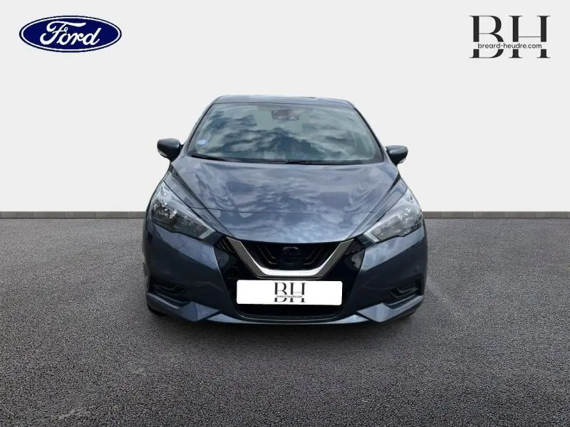 Vue frontale d'une Nissan Micra gris acier 2022 avec calandre noire et phares anguleux LED.