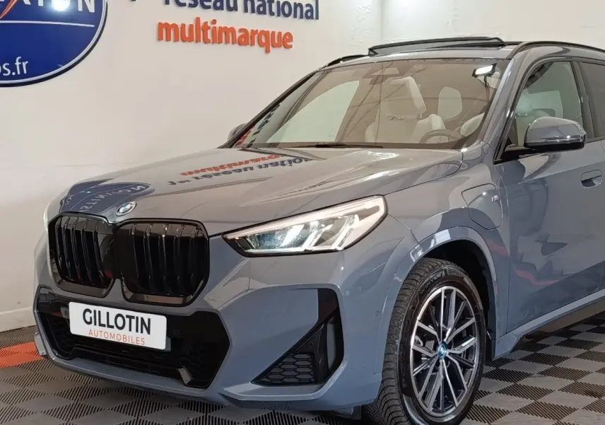 BMW X1 xDrive25e M Sport gris foncé vue 3/4 avant avec calandre noire et jantes alliage distinctives.