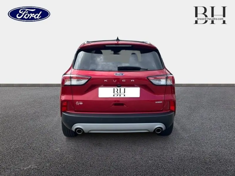 Vue arrière d'un Ford Kuga 2022 rouge Premium Lucid avec double sortie d'échappement et toit panoramique visible.