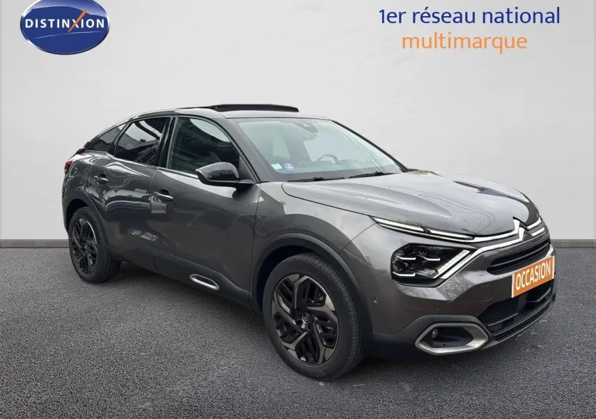 Citroën C4 PureTech 130ch gris avec toit noir, vue 3/4 avant droit mettant en valeur ses phares LED et jantes noires.