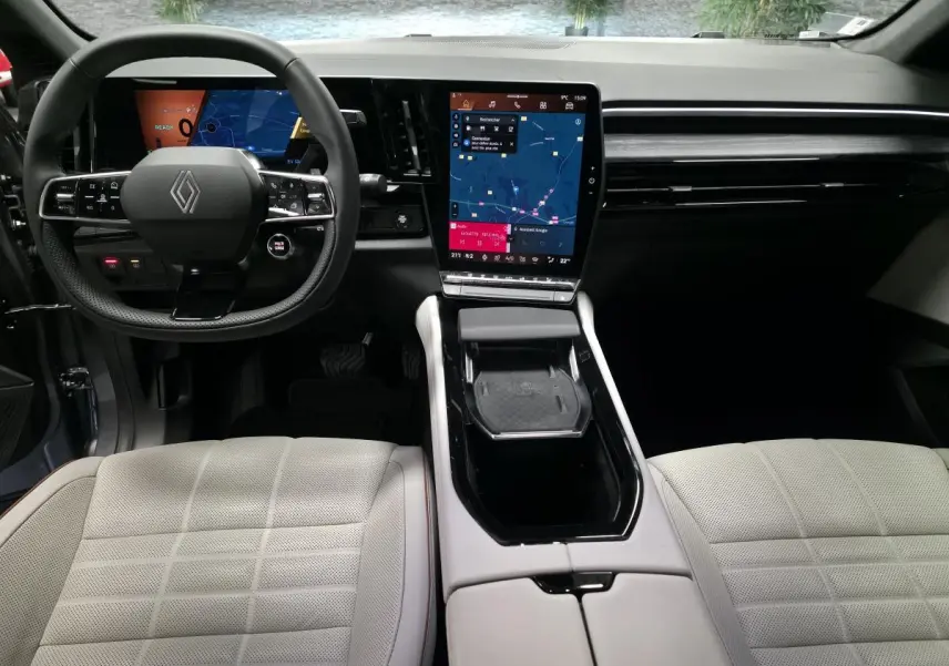 Intérieur du Renault Espace 2025, vue frontale du tableau de bord avec écran tactile vertical et sellerie textile gris sable clair.