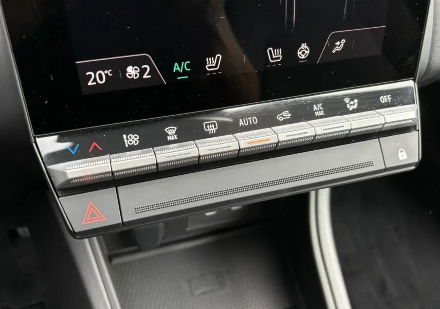Gros plan sur la console centrale du Renault Captur 2025 avec commandes climatisation et sièges chauffants.