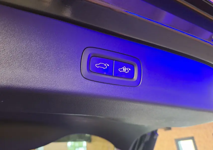 Boutons éclairés en bleu pour ouverture et fermeture automatique du hayon sur un LYNK & CO 01 noir hybride rechargeable.